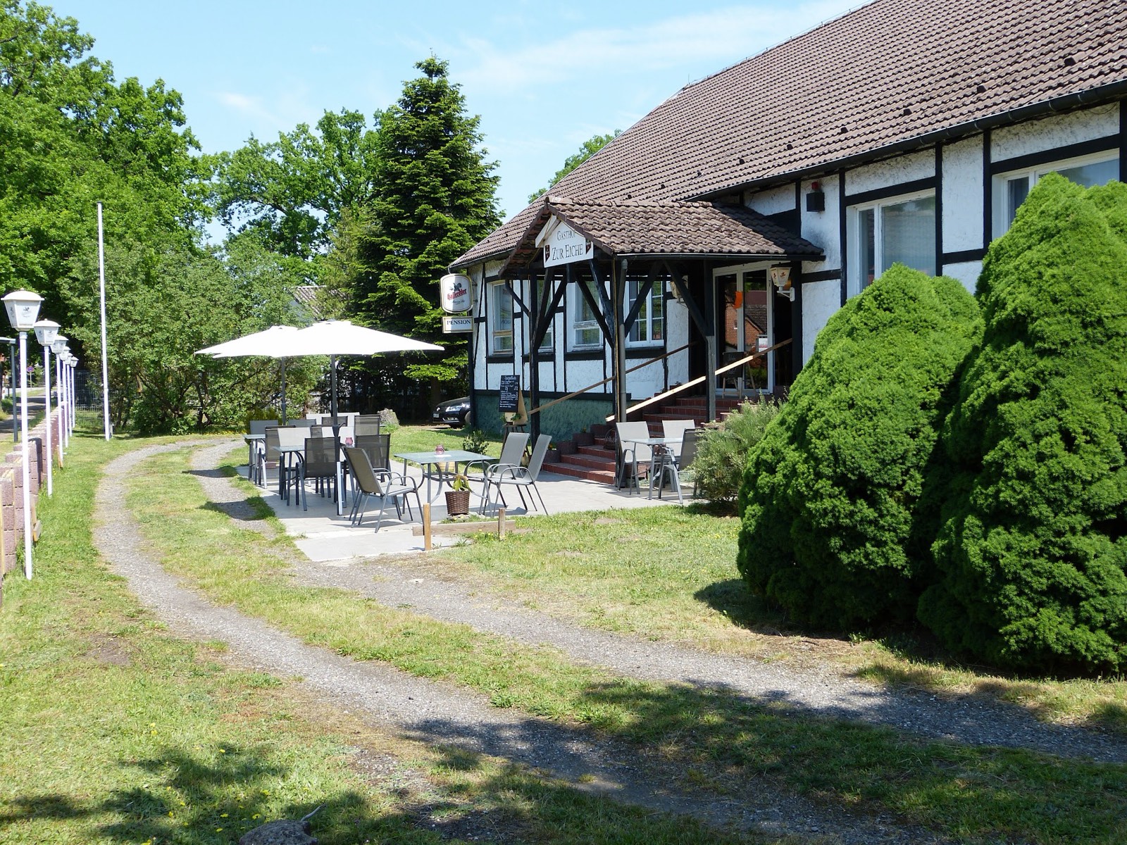 Garten und Terrasse des Gasthofs mit Sonnenschirmen
